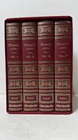 Front view of four volumes in slipcase showing gilt spines