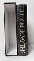 Spine of book beside empty slipcase showing title gilding