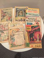 All seven comics laid out on table