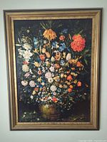 Front view of framed floral still life print in gilded wood frame