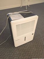 Front and side view of Frigidaire dehumidifier with power cord visible