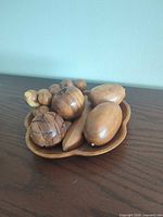 overview of all carved wooden fruits arranged on plate