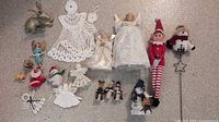 Overview of entire lot showing all ornaments, figurines, crochet pieces, elf doll and plant stake