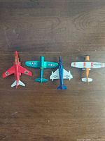 Top view of four Matchbox toy airplanes showing colours and markings