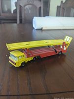 Left side view of yellow/red transporter with ramp down