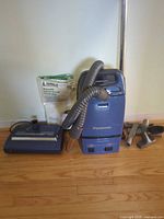 Panasonic canister vacuum with hose, wand, powerbrush head, accessory tools and bag pack