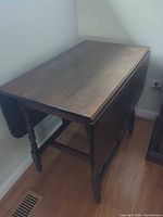 Full view of drop-leaf table with one leaf down