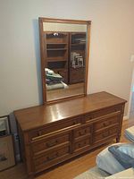 Front view of dresser with attached mirror showing overall design and finish