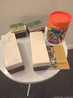 Overall lot with two long cream/brown cases, two accessory boxes, canister and manual