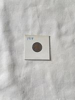 Obverse side of 1919 Lincoln Wheat cent in flip