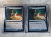 Two Dispel cards in sleeves front view