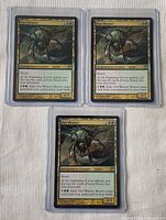 Front view of all three Nyx Weaver cards in top-loaders
