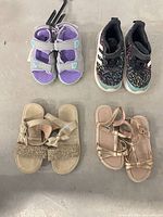 Overview of four pairs of children’s shoes on floor