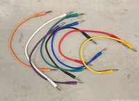 All eight multicolour 1/4 inch audio cables arranged in arc