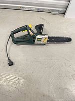 Full view of Yardworks electric chainsaw showing entire unit and cord