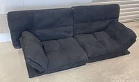 Front angled view showing overall futon shape and upholstery