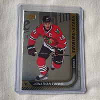 Front of 2015-16 Upper Deck Shining Stars Jonathan Toews hockey card in sleeve