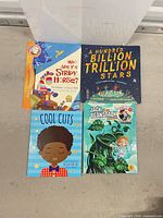Four picture books on concrete floor