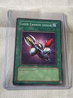 Front of Laser Cannon Armor card in sleeve