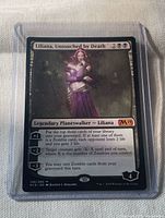 Front of Liliana, Untouched by Death card in sleeve and top loader, showing set code, collector number, rarity and loyalty abilities