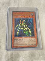 Front view of Perfectly Ultimate Great Moth card showing artwork, stats, set number DB1-EN128 in protective holder