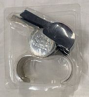 Whistle in clamshell showing maple leaf emblem and finger grip