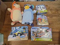 Overall lot: two plush toys and four sealed figure packs