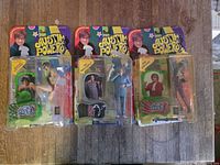 Four carded Austin Powers figures on wooden surface (three for sale)