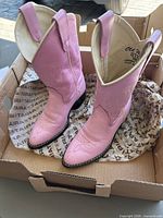 Full view of both pink cowboy boots placed in box