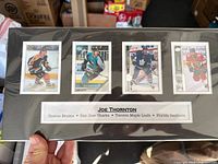 Full view of matted display showing four cards and nameplate