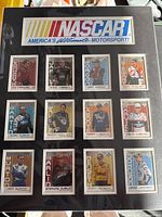 Full view of black 16x20 mat with Nascar logo header and 12 driver cards