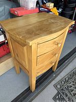 Full view of pine nightstand showing three drawers and overall design