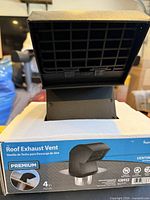 Front of boxed roof exhaust vent showing product and size