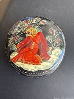 Top view showing hand painted folk scene on lid