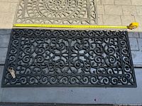 Overall view of larger scrollwork mat with tape measure for scale