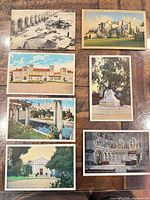 All seven postcards laid out to show fronts and overall condition