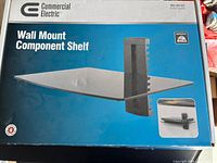 Retail box front showing Commercial Electric wall mount component shelf
