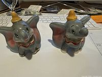 Front view of both Baby Dumbo figurines