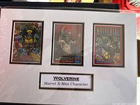 Front view showing entire 8x12 matted display with three Wolverine trading cards and title plaque