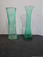 Front view of both green glass vases