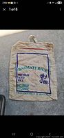 Front of beige burlap bag with "Basmati Rice Premium Aged" print