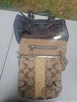 All three Coach bags stacked to show styles and sizes