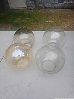 Four glass globes grouped together: two amber, two clear