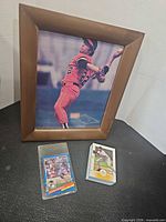 Lot overview: framed photo, sleeved Canseco card, stack of cards