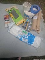 All items laid on table – masking paper, sandpaper, sanding sponges, tapes, bamboo towels