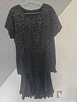Black sequined top and skirt set on hanger