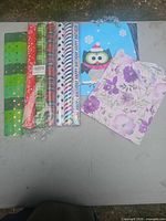 Overview of six wrapping paper rolls, two gift bags and extra sheet