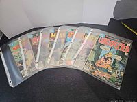 Eight comics in plastic sleeves laid out showing covers