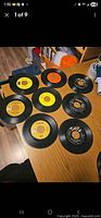 Eight 45 rpm records laid out on table