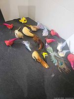 Group of decorative birds laid out on black surface